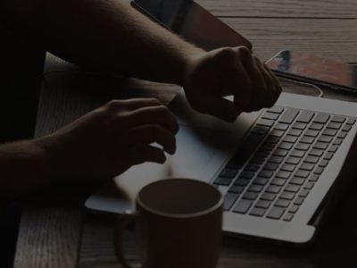 hands on top of a laptop keyboard