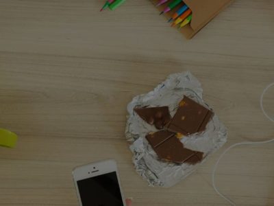 top shot of table with biscuit, juice and laptop