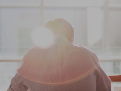 Ray of sun enlightens a photo of a guy sitting