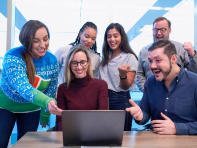 group of people looking at the laptop