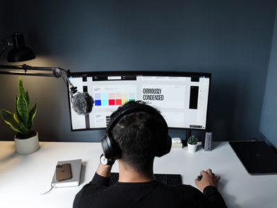 back of a man wearing headphones working