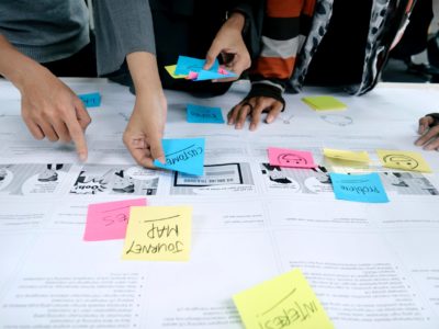 people working together putting post it notes