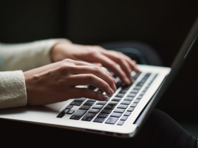 hands typing in laptop keyboard