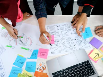 table with papers and sticky notes on top