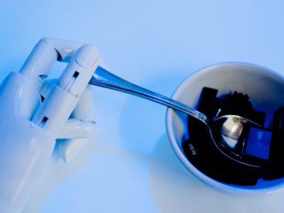 robot hands holding a spoon while scooping keys