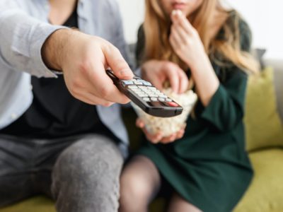 hands holding a TV remote