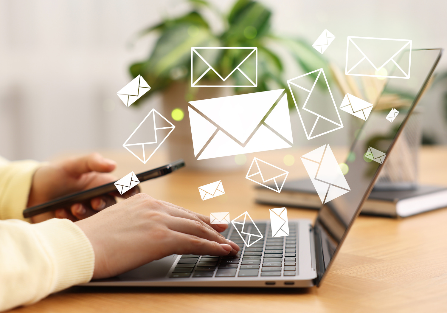 Person on a laptop with floating email icons, showing behavior tracking in lead nurture campaigns.