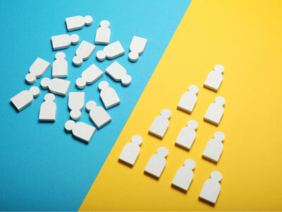 White wooden figures on blue and yellow backgrounds, illustrating the importance of clean data organization for HubSpot Philippines users.