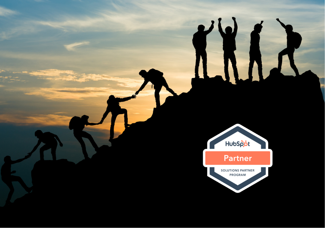 Silhouettes climbing a mountain with a HubSpot Solutions Partner badge, highlighting support from a trusted HubSpot partner Philippines.