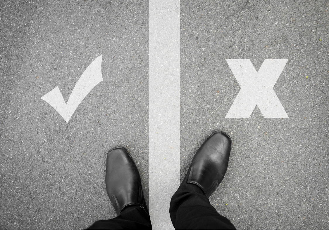 Business shoes standing between a checkmark and an X, representing the critical success factor of clean data during HubSpot implementation.