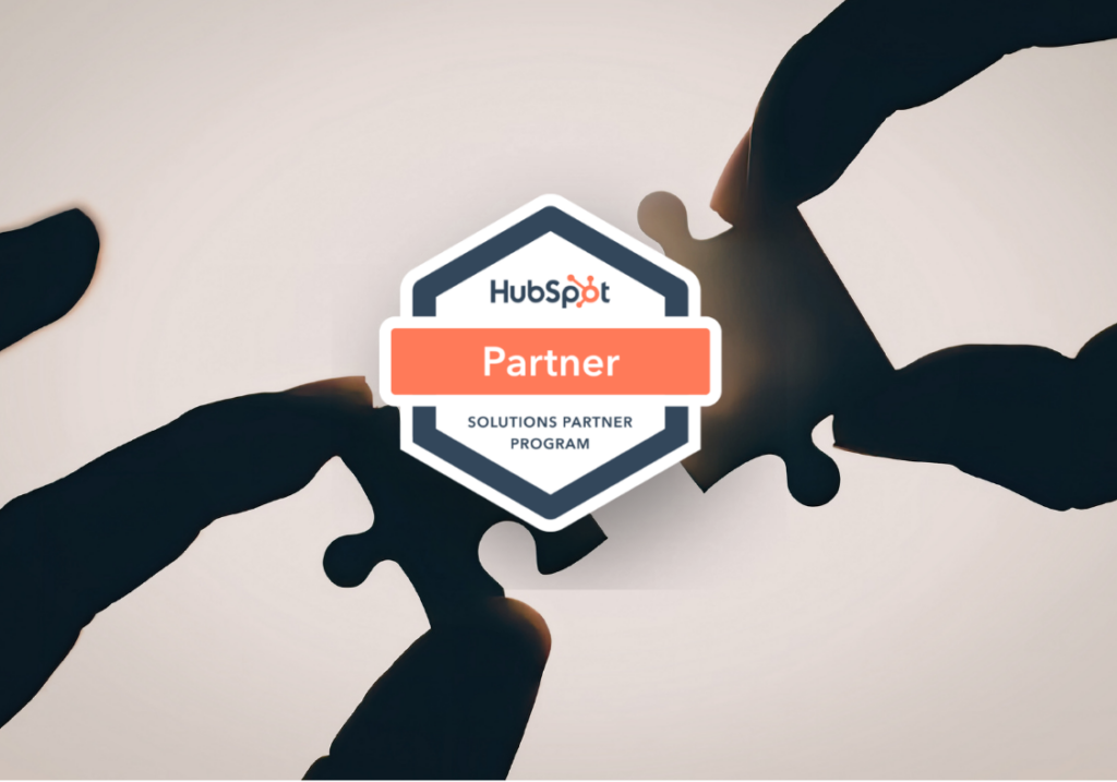 Hands connecting puzzle pieces with the HubSpot Solutions Partner Program badge, highlighting collaboration with a top HubSpot agency in the Philippines.